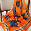 Close-up of orange silk scarf with equestrian horsebit print draped on wooden chair - 70x70cm / W-161 Orange