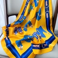 Detailed texture of silk-like scarf with yellow equestrian horsebit pattern and blue borders - 70x70cm / W-161 Yellow