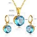 Detailed view of blue cubic zirconia pendant and earrings in gold plated stainless steel - Gold Metal With Royal Blue Stone (SE23180DG)