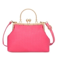 Pink woven handbag with gold metal ring handle and pearl clasp detail on white background - Rose Pink