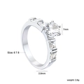 Classic silver-toned ring with 7mm round zirconia center stone and four-prong setting - US 6 / Four-Prong Round with Side Square Cut Style (RI1600A6-8S)