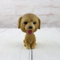 Detail of nodding golden dog car ornament with realistic fur texture and cute expression - Golden Retriever