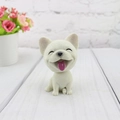 Close-up of a resin French Bulldog car ornament with matte texture and smiling face - French Bulldog
