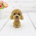 Macro detail of dark brown resin poodle bobblehead with realistic curly fur texture - Yellow Teddy