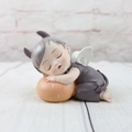 Macro detail of a sleeping baby angel resin figurine with purple horns and wings - Keller Fruit Style A (1046-9)