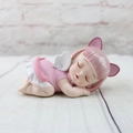 Detail of a pink resin sleeping angel doll with cat ears and white wings for cake decor - Aisha Sleeping Style B (1046-11)