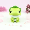 Close-up of cute green frog night light figurine with lotus leaf hat on floral background - Medium Size Money Box Style B