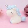 Cute white unicorn cake topper and car ornament with silver horn and blue mane in a pink setting - Blue White