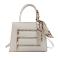 White trapezoid handbag with triple gold zipper design and silk scarf detail - White