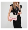 Detail of pink and beige woven crossbody bag with round buckle and detachable strap - Pink