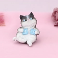 Close-up of cute grey and white resin cat figurine with blue eyes and playful signs - Mischievous (1B)