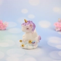 Cute resin unicorn figurine with purple mane on a white cloud base with gold stars - Purple