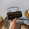 Glossy black cylindrical box bag with silver lion head handle and fine gold chain strap - Black