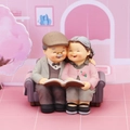 Resin elderly couple figurine on sofa reading book for cake topper and anniversary gift - Accompanying Memories (Old Couple on Sofa)