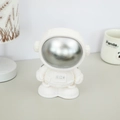 White astronaut piggy bank with silver visor and RICH logo, modern nursery decor item - Silver Style