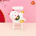 Lucky cat resin ornament in white with gold ingots on a miniature chair decoration - Lying Lucky Cat on Chair (A)