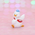 Cute white cartoon duck figurine wearing a blue sports hat and red waist bag - Mini White Duck with Blue Hat and Red Bag