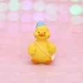 Cute yellow duck figurine wearing a blue sun hat and a mini crossbody bag - Mini Yellow Duck with Blue Hat and White Bag