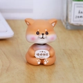 Cute Shiba Inu bobblehead ornament holding 'Keep Smiling' sign on a wooden desk - Shaking Head Shiba Inu Style (2266C)