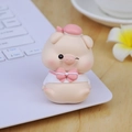 Cute pink pig figurine in sailor outfit sitting on a laptop keyboard for desk decor - Pink Winking Style (2A)