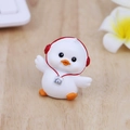 Cute white duck figurine with red headphones and camera on wooden desk surface - Headphone & Camera Style - White