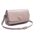 Nude pink textured leather cylinder bag with silver chain strap on white background - Pink