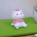 Cute resin cat figurine ornament with pink hat and cape on a green notebook surface - Style A Cat
