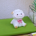 Cute white cartoon sheep figurine with pink bow tie sitting on a green notebook - Style E Sheep