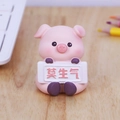Cute pink pig resin figurine holding a Mo Sheng Qi sign for office desk decoration - Motivational Pig Style (B)