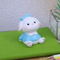 Cute resin rabbit figurine with blue bow and dress sitting on a green notebook - Style F Rabbit