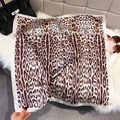 Detail of leopard print silk scarf with cream borders on soft plush background - White