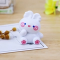 Cute white resin rabbit figurine with pink flower paw detail for car or desk decor - Curious Sitting Pose (C Nana)