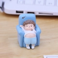 Cute boy figurine sitting on a blue sofa with a slacker theme for desk decor - Style E Swaying Baby (Letting it Go!)
