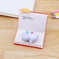 Cute animal phone holder ornament featuring a sleeping purple bear on a red book base - Sleeping Cat Ornament