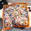 Detail showing equestrian silk scarf with golden chains on soft white faux fur - Orange Border