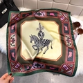 Detail of a zebra print silk scarf with vintage ornate patterns next to a black handbag - 65*65cm / Green