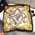 Detail shot of luxury silk scarf with gold chain and floral baroque pattern on a bag - Black / 65*65cm