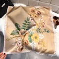 Close-up of floral silk scarf texture on white fur next to a stylish handbag - Bandana / Light Camel