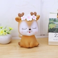 Cute brown cartoon deer piggy bank with heart antlers and white flower on wooden desk - 4A Brown Deer Small Size Closed Eyes