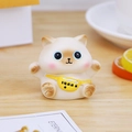 Cute fortune cat figurine with yellow waist bag and 'Happiness' text on desk - Backpack Cat Ornament