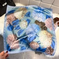 Close-up of floral print silk scarf displayed on a white rug with premium accessories - Hydrangea Print / Peacock Blue (W-530)