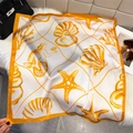 Detail of square silk scarf showing hand-drawn seashell and mermaid prints on satin - Ocean Seashell Print / Orange