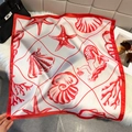 Elegant silk scarf with red sea shell and starfish print styled with luxury accessories - Ocean Seashell Print / Red