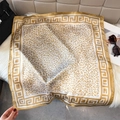 Detailed view of leopard print satin square scarf with Greek key border and soft sheen - Champagne Gold