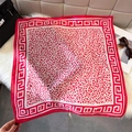 Red and white leopard print silk scarf with Greek key pattern on plush background - Deep Pink