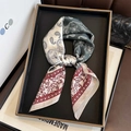 Elegant paisley print silk scarf with vintage patchwork patterns on a black display tray - 65x65cm / Red Border Paisley