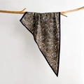 Detail showing paisley silk scarf draped over a wooden branch on a white background - 88*136*64cm / Olive Brown