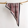Women's paisley silk scarf in burgundy and black draped on a rustic branch - Red