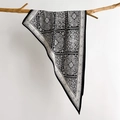 Chic black and white paisley silk shawl displayed elegantly on a natural wooden branch - Black