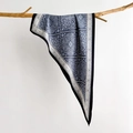 Detailed macro shot of vintage blue paisley silk scarf draped on a wooden branch - Blue
